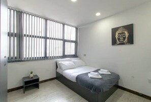 Desk, iron/ironing board, bed sheets