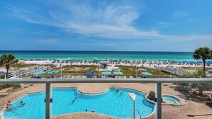 Área da piscina com vista para a praia e oceano.