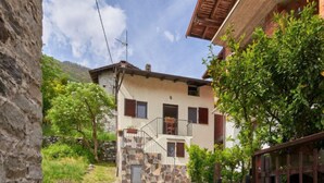 A stone staircase leading to a two-story building with a stone facade and wooden shutters. - Casa Dascio by Interhome (Sorico Albonico)