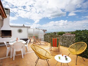 A patio with outdoor furniture, a table, and a view of the landscape. - Le Montcey by Interhome (Cagnes-sur-Mer)