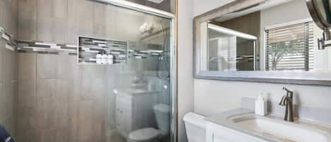 Bathtub, hair dryer, towels, shampoo
