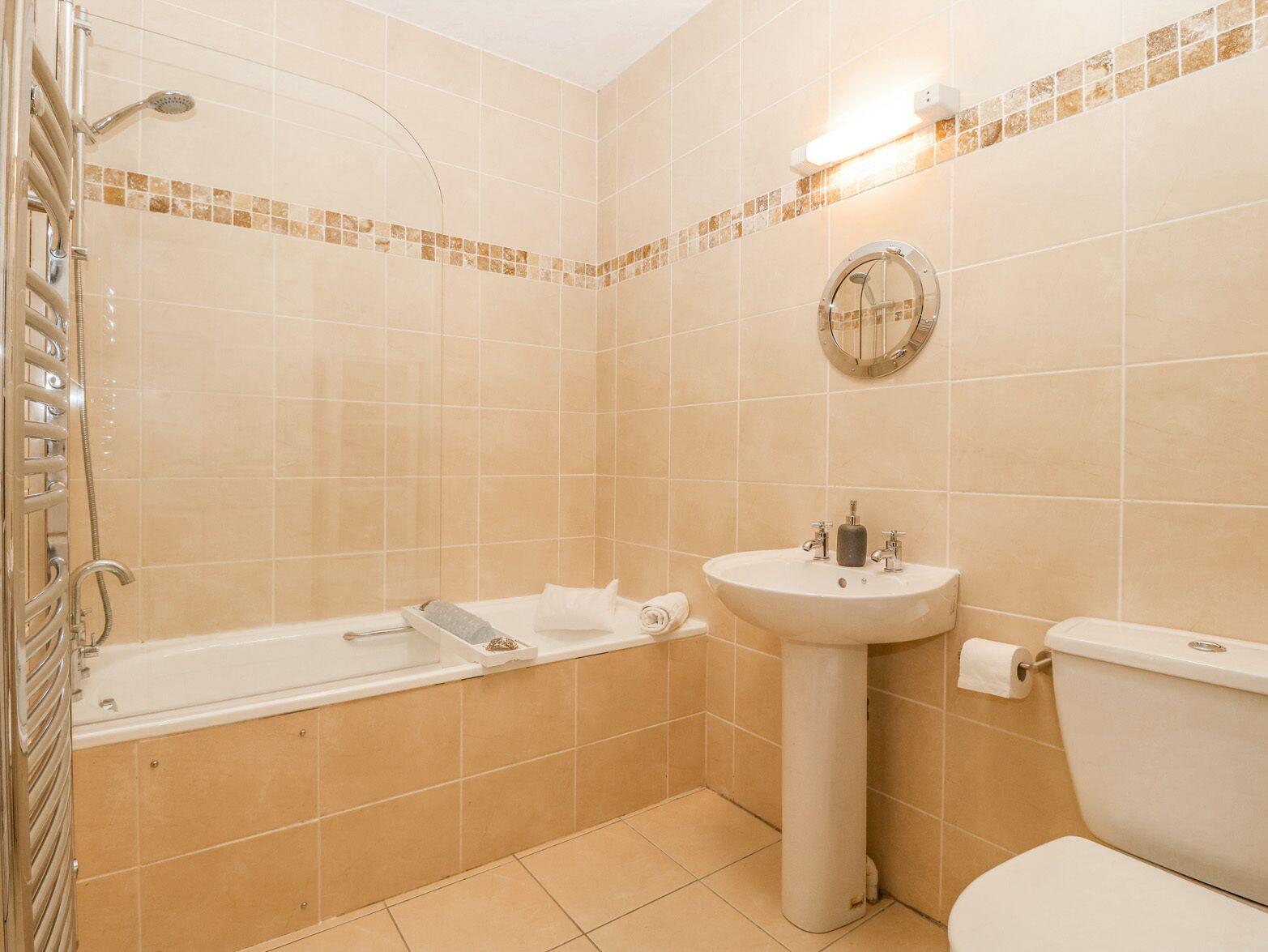 A bathroom with a bathtub, a sink, and a toilet.