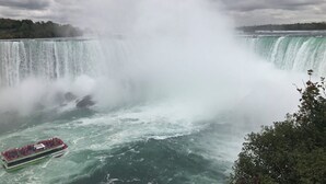 A large waterfall with a boat in the foreground. -  Cozy room studio (Niagara Falls)