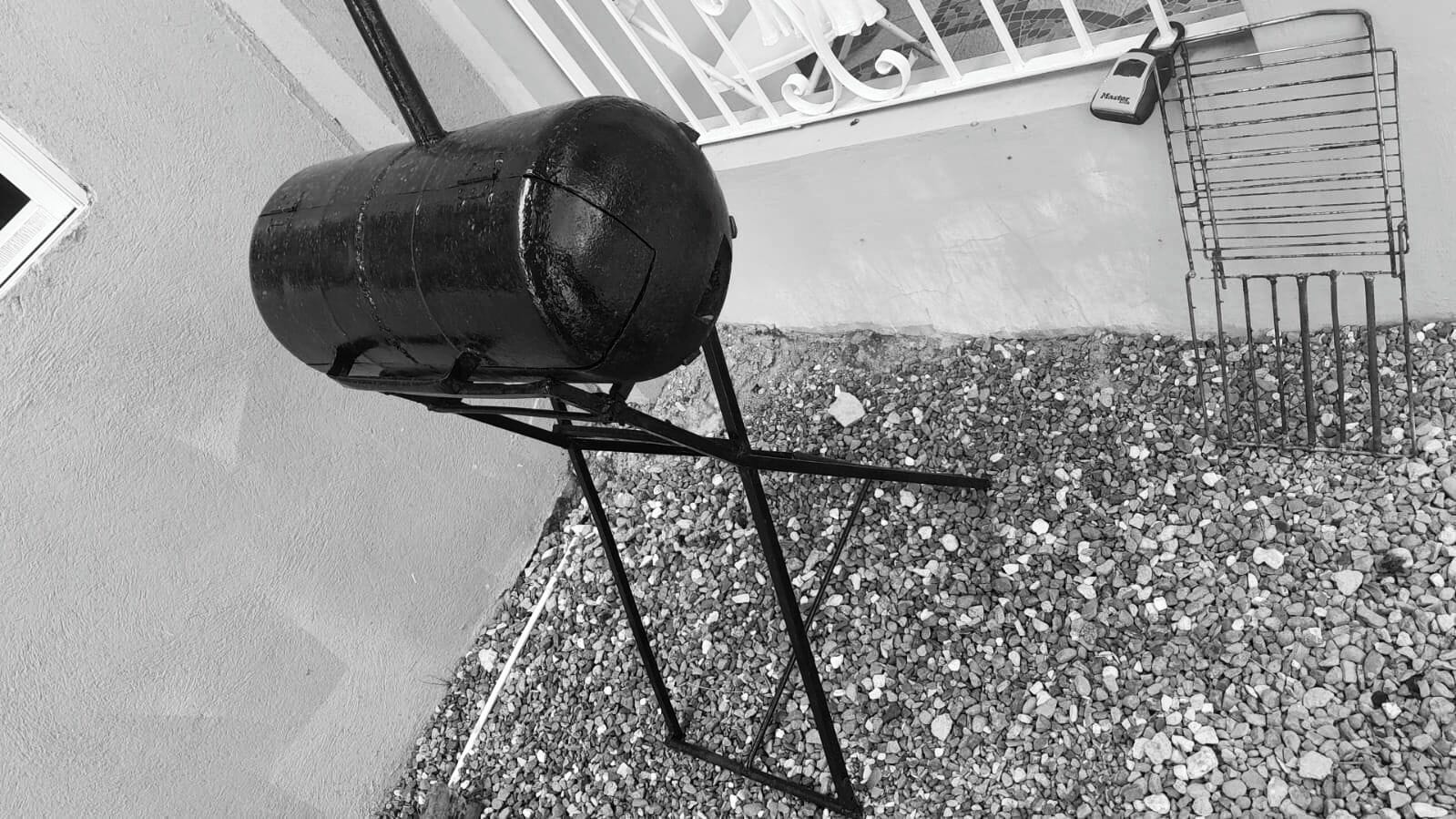 A barbecue grill on a stand outdoors.