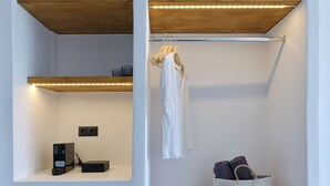 A modern closet with wooden shelves, a hanging rack, and a basket. - PAROS FIVE SENSES (Paros)