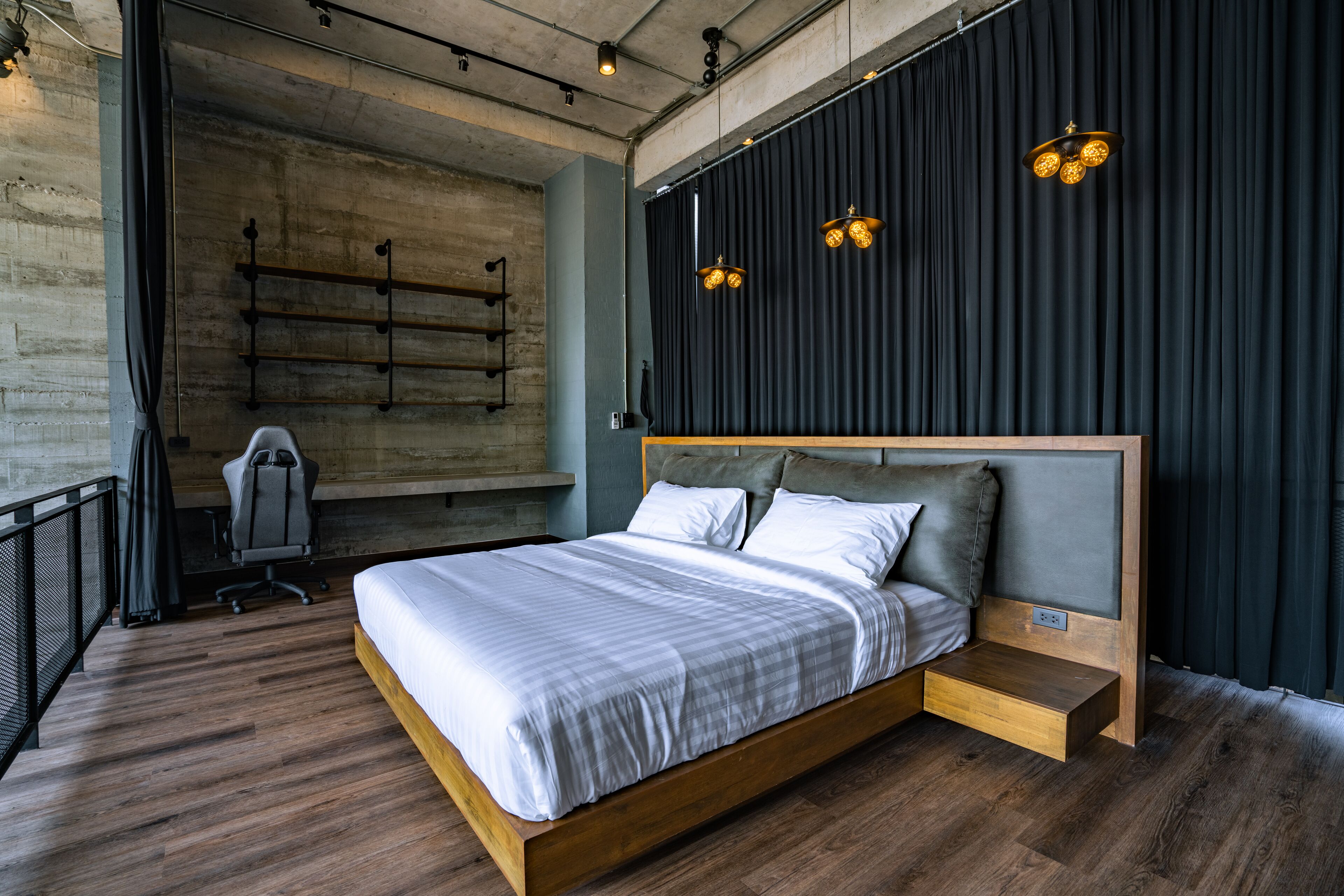 A modern bedroom with a wooden bed, a desk, and a chair.