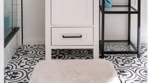 A bathroom with a white cabinet, a black shelf, and patterned floor tiles. - Coastal Guest House in Nature (Carpinteria)