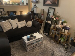 Relax in this inviting space with a sofa, coffee table, and potted plant.