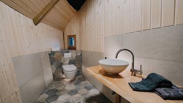 Comfort Chalet | Bathroom | Hair dryer, slippers, towels, toilet paper