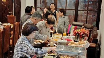 A communal dining area with a buffet setup, including a toaster and a coffee pot.