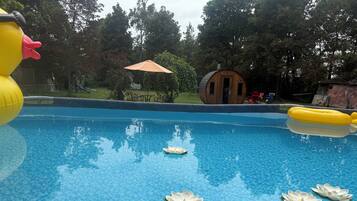 A swimming pool with inflatable toys and artificial flowers.