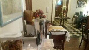 A buffet table with various food items and a large container of snacks. - alojarseenmendoza  (Mendoza)