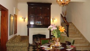 A formal living room with a fireplace, a chandelier, and a staircase. - alojarseenmendoza  (Mendoza)