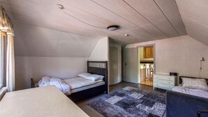A bedroom with a bed, a desk, a chair, a rug, and a ceiling light. - Awesome home in Eldsberga with kitchen (Eldsberga)