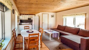 A cozy cabin interior with a dining area, kitchen, and living space. - Awesome home in Eldsberga with kitchen (Eldsberga)