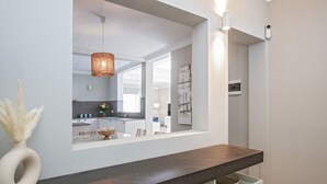 A modern kitchen with a dark countertop, a hanging light fixture, and a large window. - Stunning 4 Bedroom Villa on Prestigious Development (Playa Blanca)