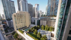A high-rise building with a rooftop garden, multiple floors, and a mix of modern and traditional architectural styles.