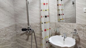 A bathroom with a shower, a sink, a mirror, and a toilet. - Naqshband Craft Center & Hotel (Bukhara)