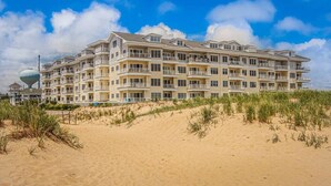 A multi-story hotel with balconies, located near a beach with sand dunes. - Beachfront Penthouse!  4Bd/3Bth (Virginia Beach)