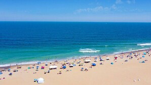 A beach with numerous umbrellas and people. - Beachfront Penthouse!  4Bd/3Bth (Virginia Beach)