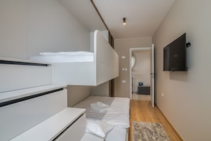Cozy retreat with a bed, storage, and flat-screen TV.