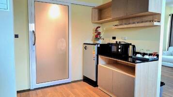 Exclusive Studio Suite | Private kitchen | Fridge, electric kettle, dining tables