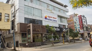 A multi-story building with a modern design, featuring a prominent sign for 'MySpace Kadison' and 'Toshanani Emporia'.