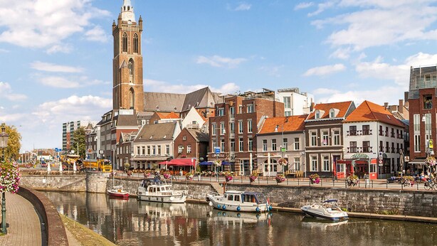 A canal with boats, historic buildings, and a prominent tower. - Gorgeous home in Roermond with kitchen (Roermond)
