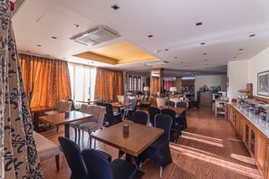 Enjoy a spacious room with a dining area, kitchen, and bar counter, perfect for relaxing and entertaining.