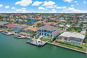 A residential area with houses, a marina, and a large swimming pool.