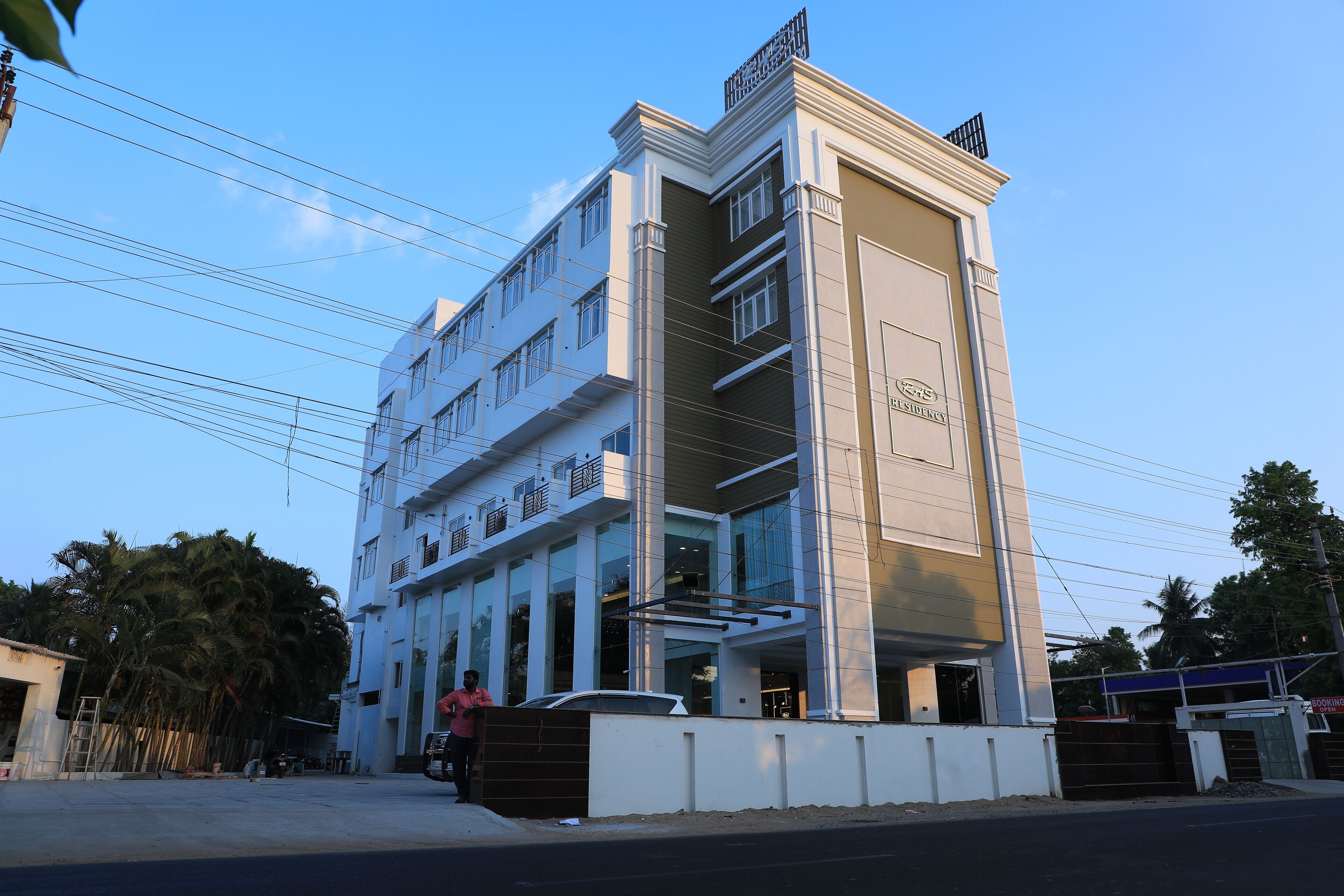 A multi-story hotel with a modern design, featuring balconies and large windows.