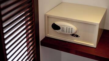 A safe with a keypad on a wooden surface.