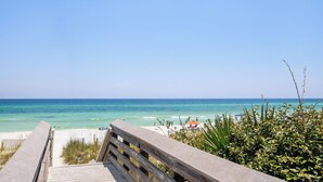 A wooden boardwalk leading to a beach with clear turquoise water and a clear sky. - Gulf Views-Resort Style Community! (Santa Rosa Beach)