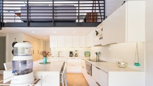 A modern kitchen with white cabinets, a built-in oven, and a coffee machine. - Private Rooftop Terrace + Walkable to the Beach (Bays of Huatulco)