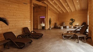 A wooden interior with lounge chairs and a massage table, suggesting a spa or relaxation area. - Doppelhaushälfte in Hasselfelde (Hasselfelde)