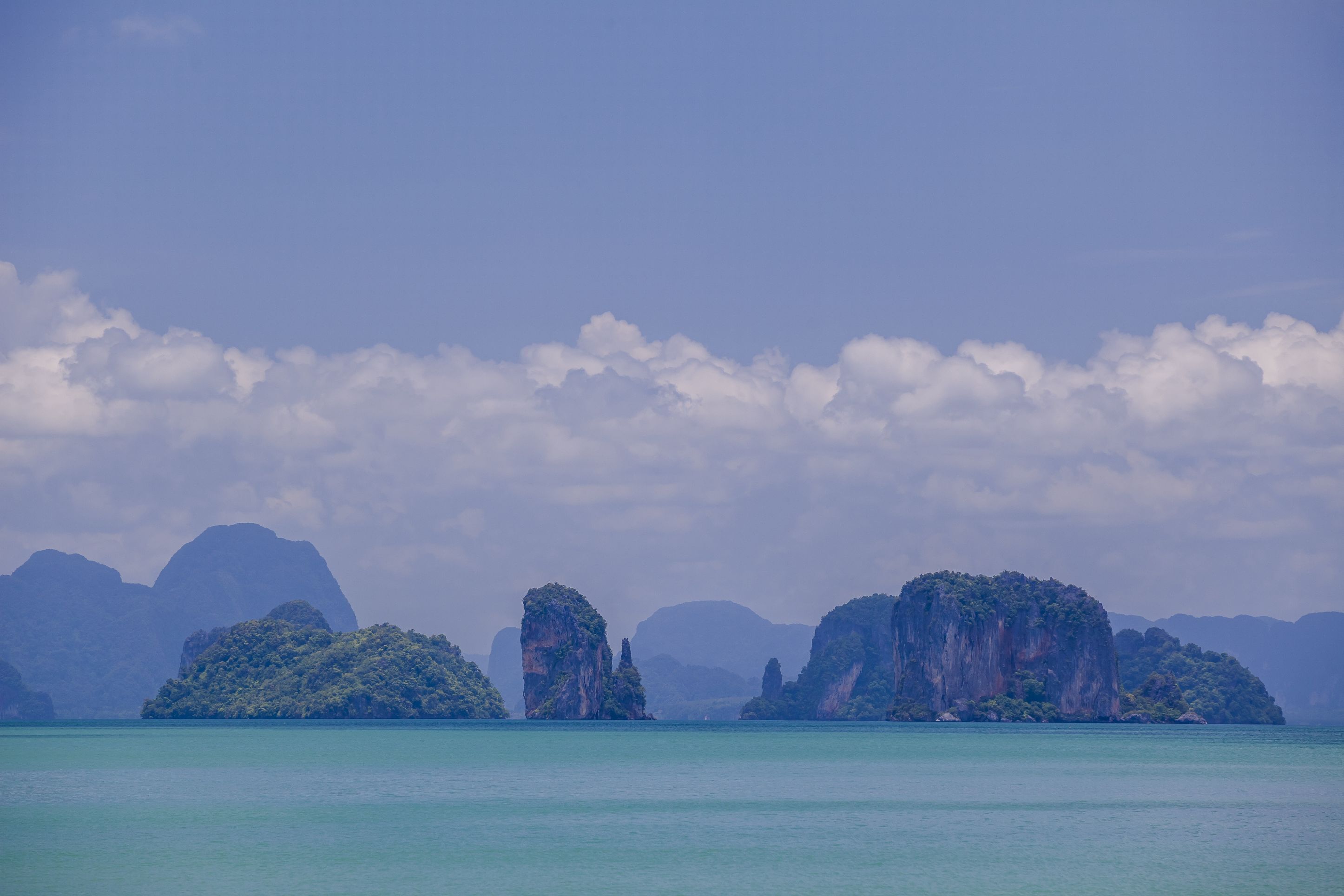 A coastal landscape with multiple islands and clear blue water.
