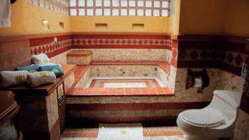 Bathroom features a bathtub and a white toilet.