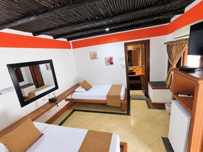 A compact hotel room with two beds, a large mirror, a television, and a small kitchenette. - Hotel Porton del Sol  (Santa Fe de Antioquia)