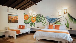 A hotel room with two beds, a mural with birds and flowers, and a small table. - Hotel Porton del Sol  (Santa Fe de Antioquia)