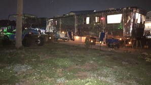 A large, open-sided structure with a flat roof, possibly a mobile home or RV, parked on a grassy area at night. - Antique1958Spartan CamperOceanLakes Cmpgrnd, I-33.Golf Cart for July,Aug rentals (Myrtle Beach)