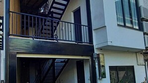 A modern two-story building with a balcony on the upper floor. - A BA LI BI Duck (Tainan)