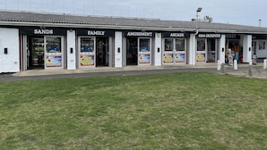 A building with multiple entrances labeled 'SANDS', 'FAMILY', 'AMUSEMENT', 'ARCADE', and '500 JACKPOTS MARKET'. - M & T Chalets.  Refurbished Chalet sleeps 5, in Scratby , 5 mins to the beach. (great yarmouth)