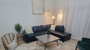 A modern living room with a sectional sofa, two armchairs, a coffee table, and decorative lighting. - The Ritz serene spa sanctuary hot tub, mountain view, patio for the whole family (Las Cruces)