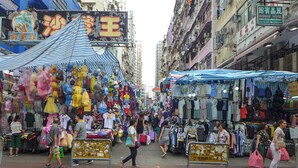 A bustling street market with various stalls selling clothes and toys. - Cozy hostel 2 pax, airport 30mins, 2mins Mongkok MTR,many tourist spots nearby. (Kowloon)