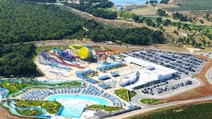 An aerial view of a water park with multiple water slides, a large pool, and a parking area. - Villa Salvore - new house near beaches, pool, summer kitchen, playroom, Istria (Savudrija)