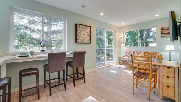 A spacious kitchen with a large island, bar stools, and a dining area with a wooden table and chairs. - 13 Mi to Dtwn Seattle! 'The Nest' Apt w/ Balcony (Bellevue)