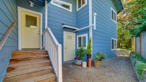 A two-story house with a wooden staircase leading to a front door, a small front porch, and a gravel driveway. - 13 Mi to Dtwn Seattle! 'The Nest' Apt w/ Balcony (Bellevue)