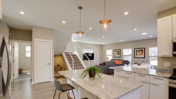 A modern kitchen with a central island, stainless steel appliances, and pendant lighting. - Spacious Minneapolis Vacation Rental w/ Game Room! (Minneapolis)
