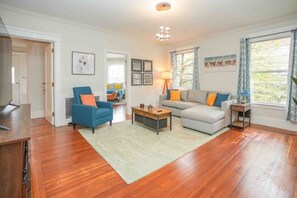 Relax in this inviting living room with a comfortable sofa, armchair, and coffee table.