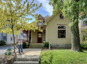Traditional home with a charming front porch and well-manicured lawn.